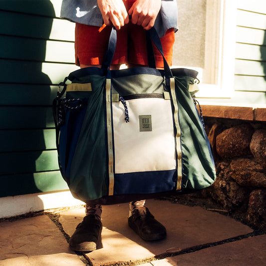 General lifestyle image of Mountain Gear Bag in "Forest / Bone White"