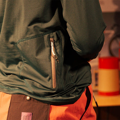 General rear pocket detail view of Topo Designs Sun Hoodie - Women's in "Dark Pine"