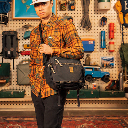 General on model shot of Mountain Cross Bag in "Black / Neutral" worn crossbody