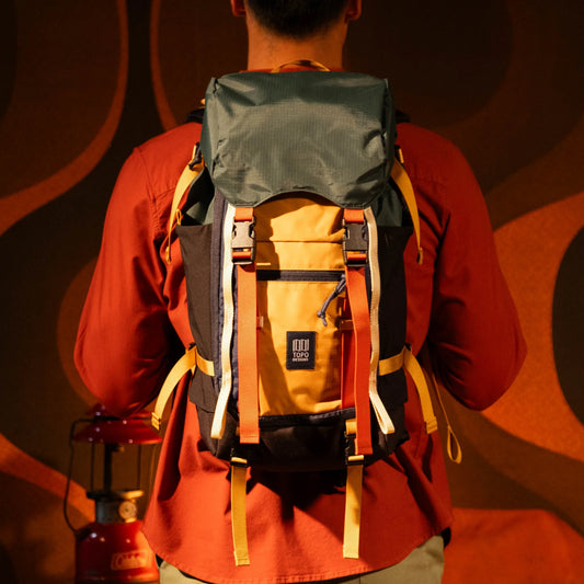 General lookbook on model photo of Rover Trail Pack in "Forest / Goldenrod"