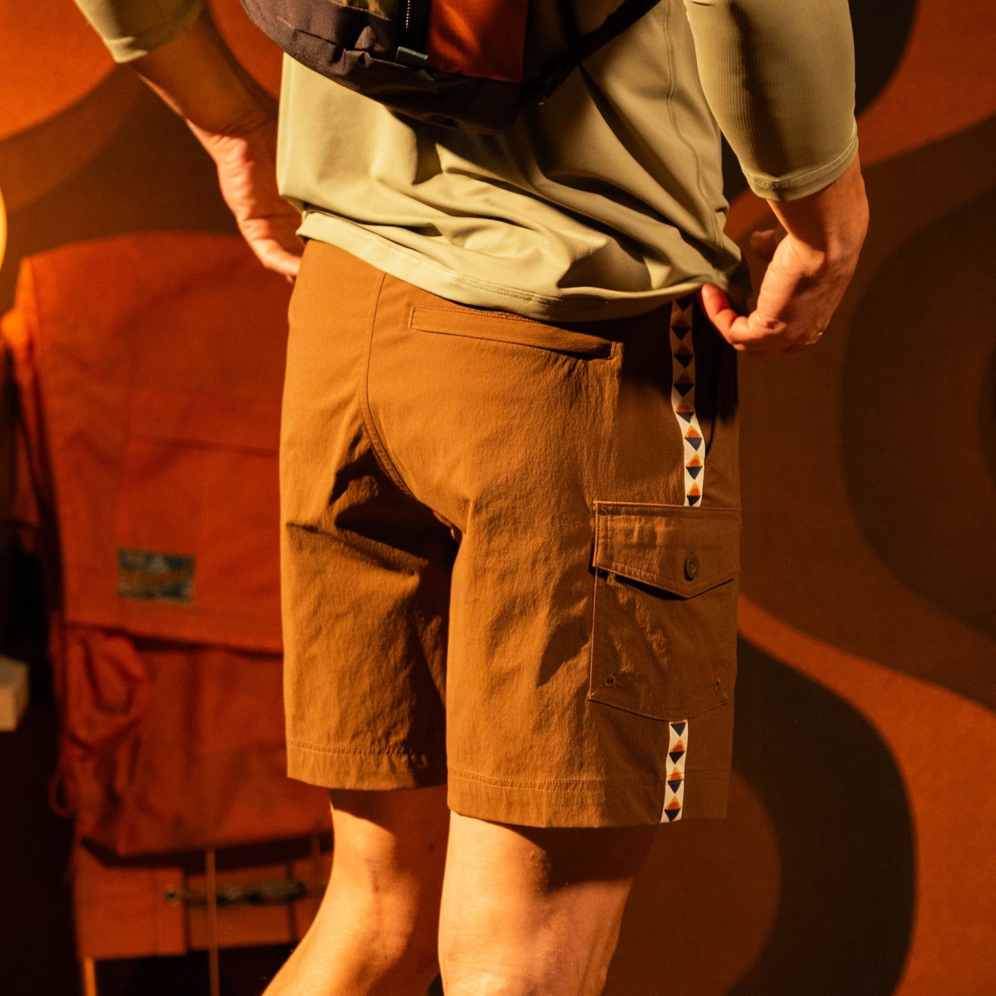 General model lifestyle photo of Topo Designs Mountain Wave Shorts on male model in "Desert Palm"