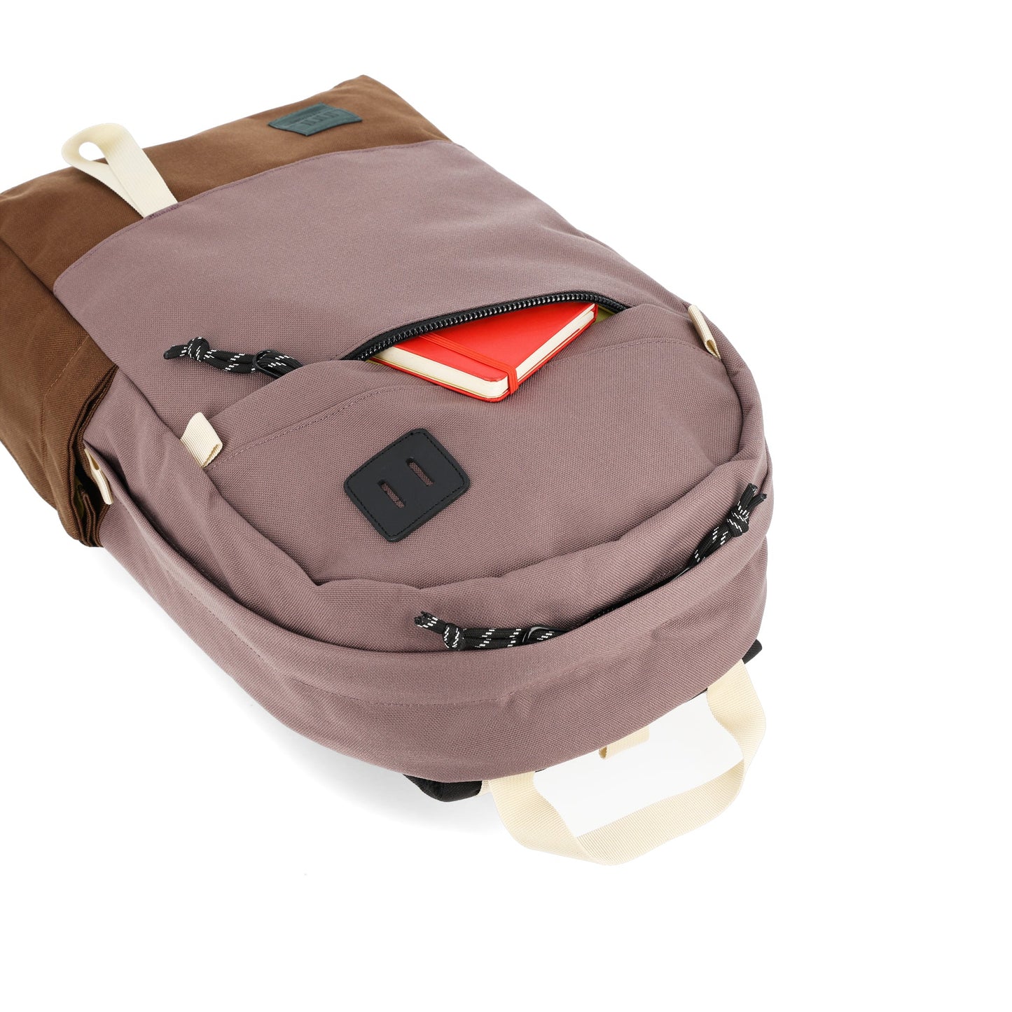 General detail shot of front zipper pocket on Topo Designs Daypack Classic 100% recycled nylon laptop backpack for work or school in "Peppercorn / Cocoa" purple brown