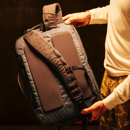 General shot of Topo Designs Global Pro 3-Way Briefcase in studio setting showing backpack straps
