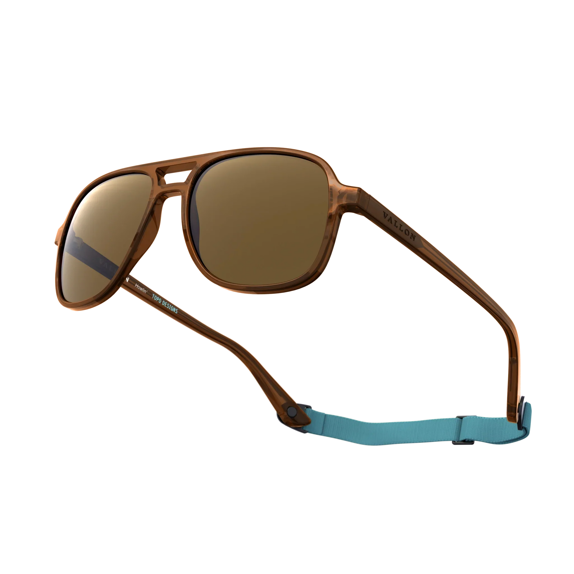 General alternate angled view of VALLON X Topo Designs sunglasses in "Brown / Brown" with sunglass arms open with strap attached.