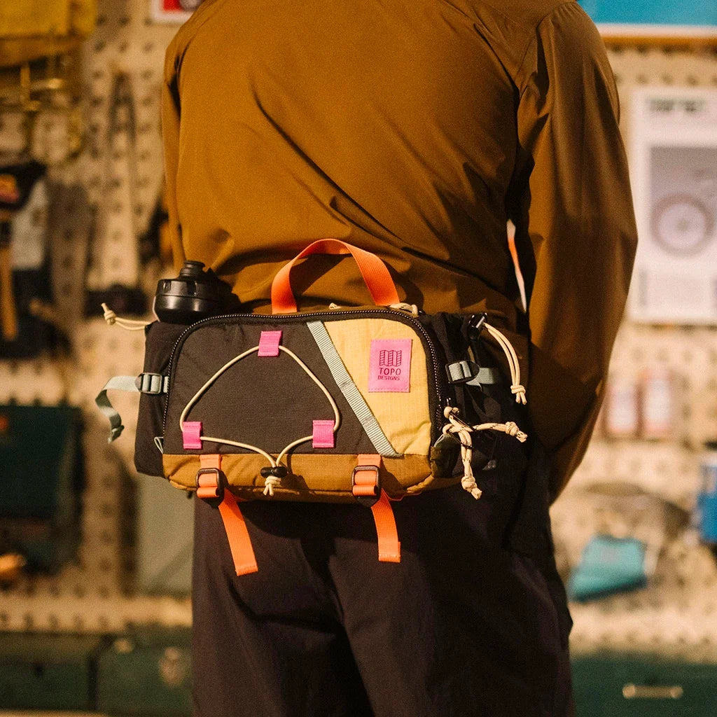 General Lookbook On Model Shot of Mountain Hydro Hip Pack in "Desert Palm / Sahara"
