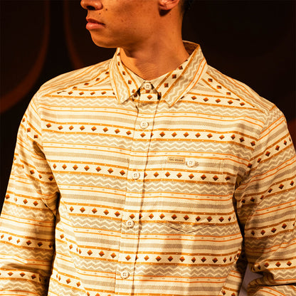 General lifestyle image of person wearing a "Bone White Sunset Stripe" Mountain Shirt Lightweight with a dark background