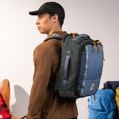General on Model image of Global Travel Backpack in "Stone Blue / Forest"