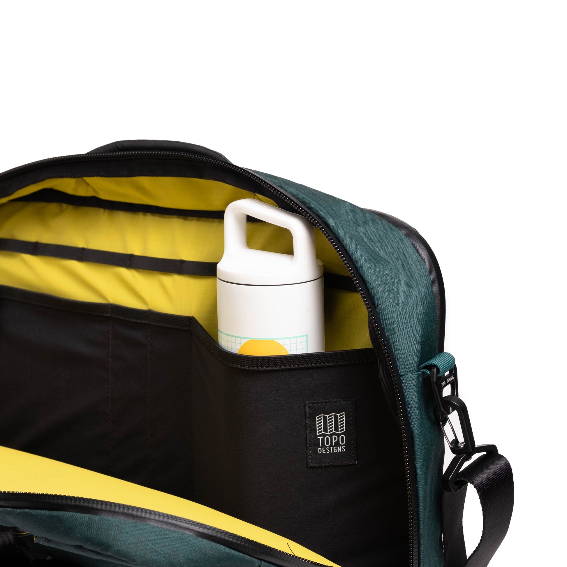 General shot of Topo Designs Global Pro 3-Way Briefcase showing interior pocket water bottle sleeve