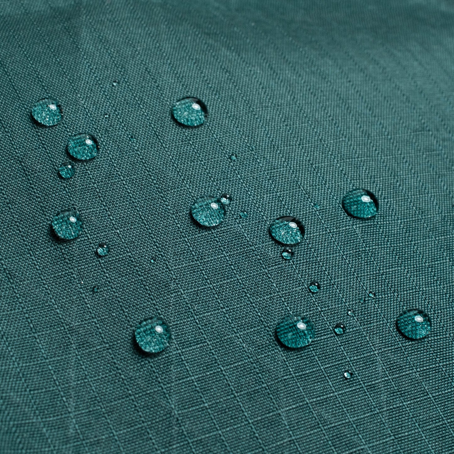 General shot of Topo Designs Global Pro Tech Case water droplets on waterproof material