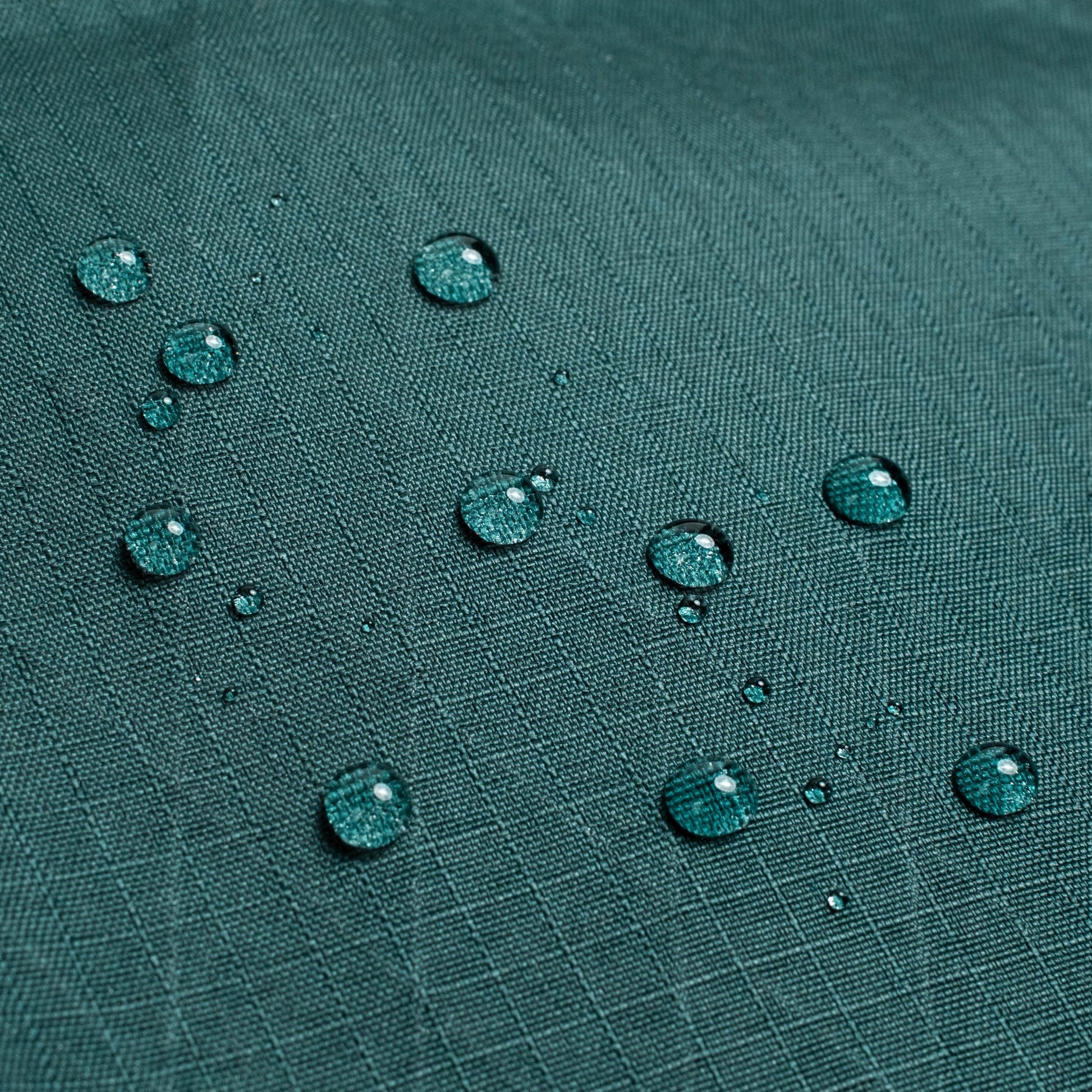 General shot of Topo Designs Global Pro Tech Case water droplets on waterproof material