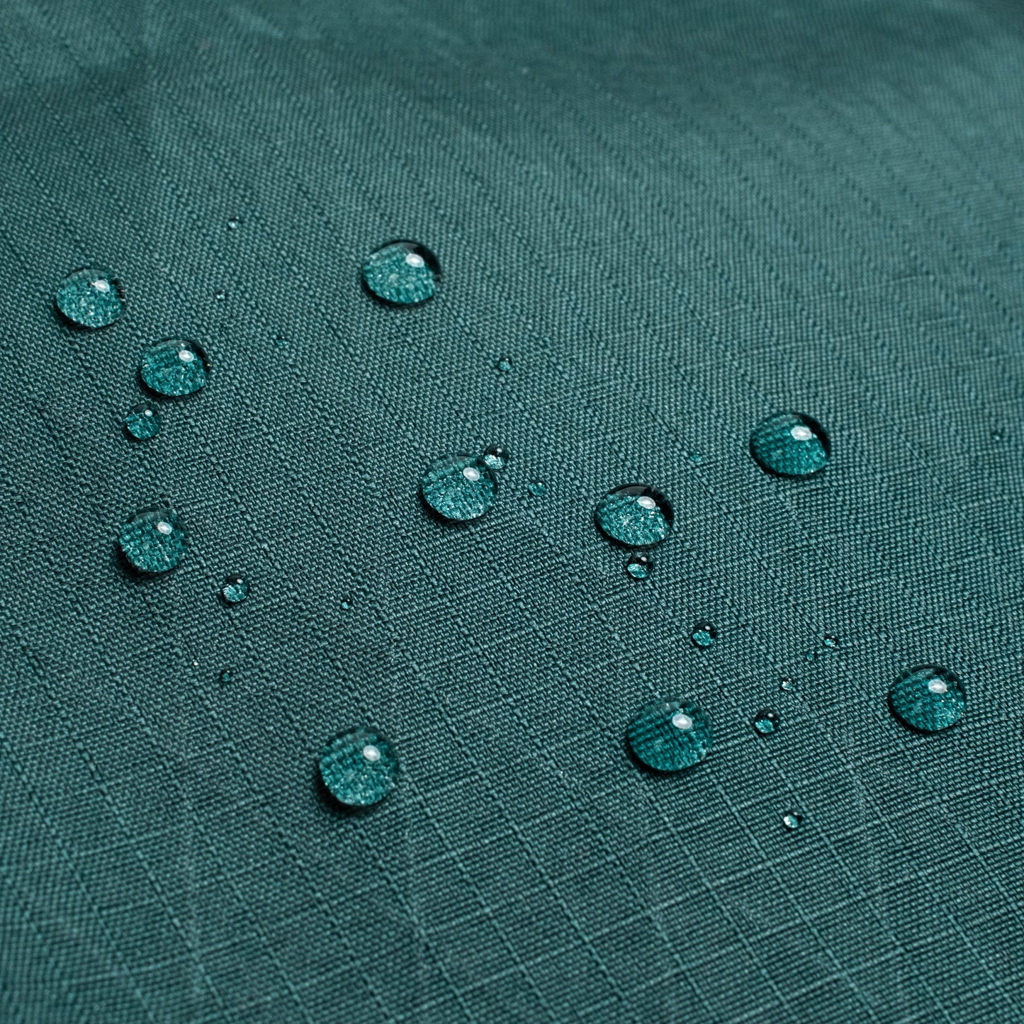 General back shot of Topo Designs Global Pro Travel Roller Bag showing water droplets on waterpoof material