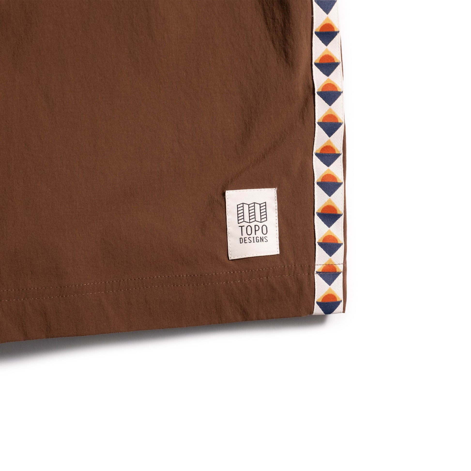 General front logo detail white background flat lay image of Topo Designs Mountain Wave Short - Men's in "Desert Palm"
