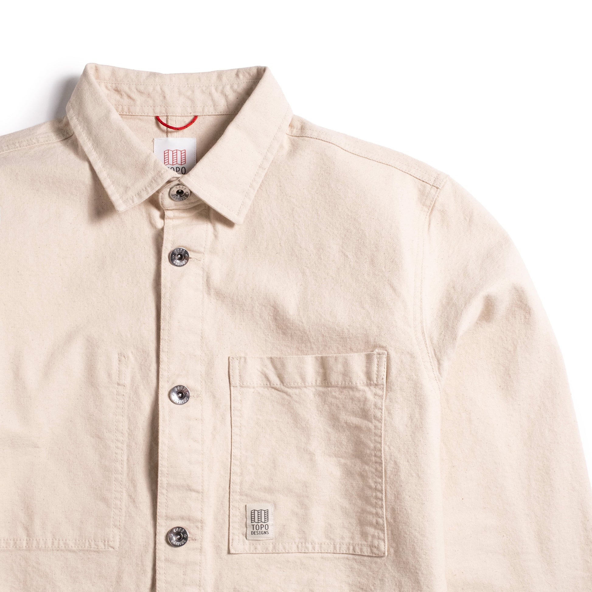 General front detail collar and pocket view of Topo Designs Utility Jacket Undyed - Men's in "Undyed"