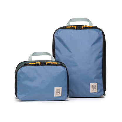 Front white background image of Topo Designs Global Compression Pack Bag Set in "Stone Blue / Forest"