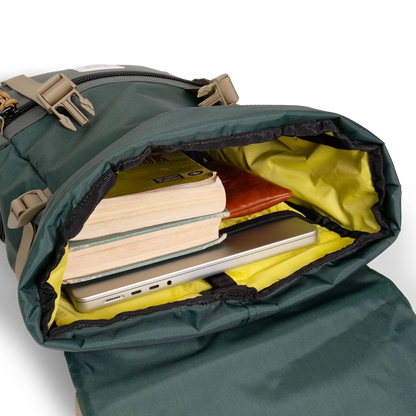 General shot Topo Designs Rover Pack Classic laptop backpack in "Forest" showing interior shot of backpack packed out with laptop, books, and glasses case.