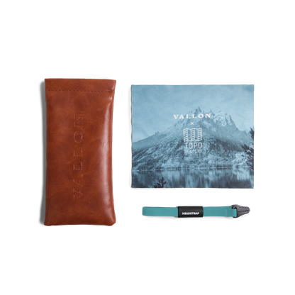 General view of VALLON X Topo Designs sunglasses accessories in "Brown / Brown" with microfiber cloth, leather sunglasses case, and sunglasses strap.