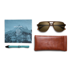 General view of VALLON X Topo Designs sunglasses in "Brown / Brown" with microfiber cloth, leather sunglasses case, and sunglasses strap.