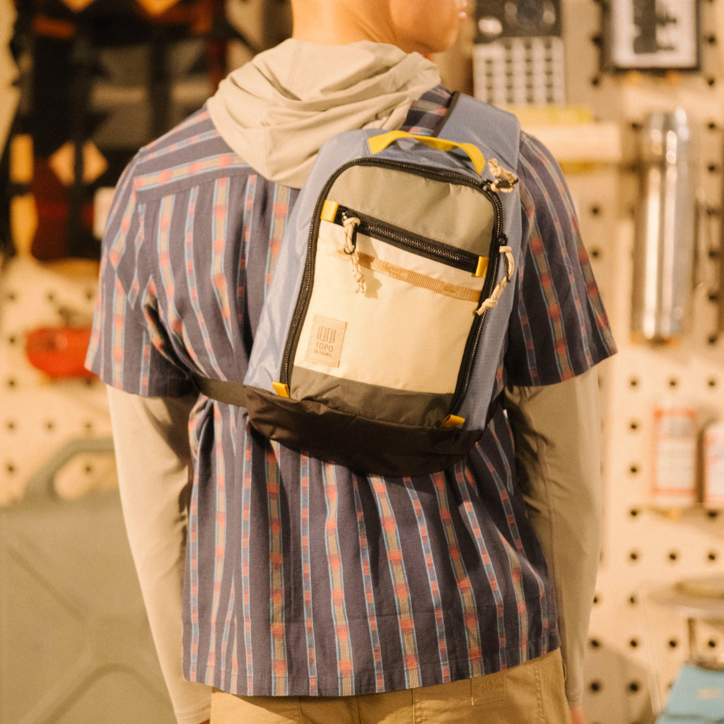 General lookbook on model image of Mountain Sling Bag in "Stone Blue / Bone White"